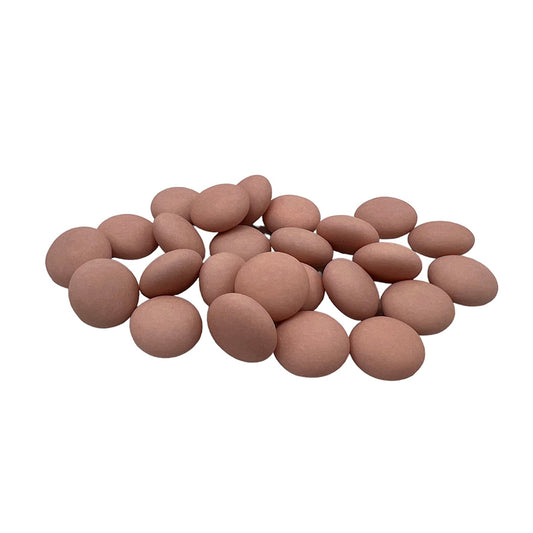 Een verzameling matte confetti suikerbonen in oudroze kleur, geschikt voor doopsuikerconcepten.